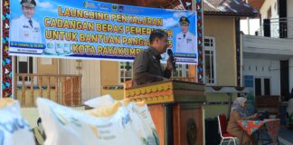 Plt. Asisten II Setdako Payakumbuh, Wal Asri, memberikan sambutan saat launching penyaluran cadangan beras pemerintah untuk bantuan pangan tahun 2025 di Kelurahan Koto Baru Payobasung, Selasa (22/07/2025).