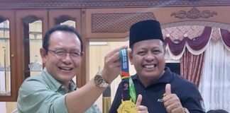 Wali Kota Payakumbuh Zulmaeta bersama Ketua KORMI Kota Payakumbuh menunjukkan medali emas hasil prestasi atlet pada FORNAS VIII di Mataram.
