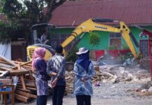 Petugas Dinas PUPR Kota Payakumbuh bersama Satgas Penertiban memantau proses pembongkaran bangunan liar di atas lahan milik pemerintah di Jalan Imam Bonjol, Kamis (13/11/2025).